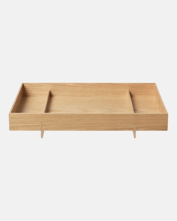 The simple and super functional ABENTO tray, by designer Adam Miller for blomus, gets its name from the traditional Asian Bento box – it is specially designed to carry a portion of home-made food, as is the custom in Japanese, Taiwanese and Korean cuisine. This design inspired the look of this simple, yet sculptural wooden tray, which is available in two sizes. It is perfect for use in the kitchen, bathroom, spa, the office – or anywhere else you might need a tray. The two feet of the ABENTO tray, which make it easy to hold, cross the body of the tray and simultaneously separate the tray area into three sections. A great helper for everyday use. The tray is also a very decorative object when it is not in use.