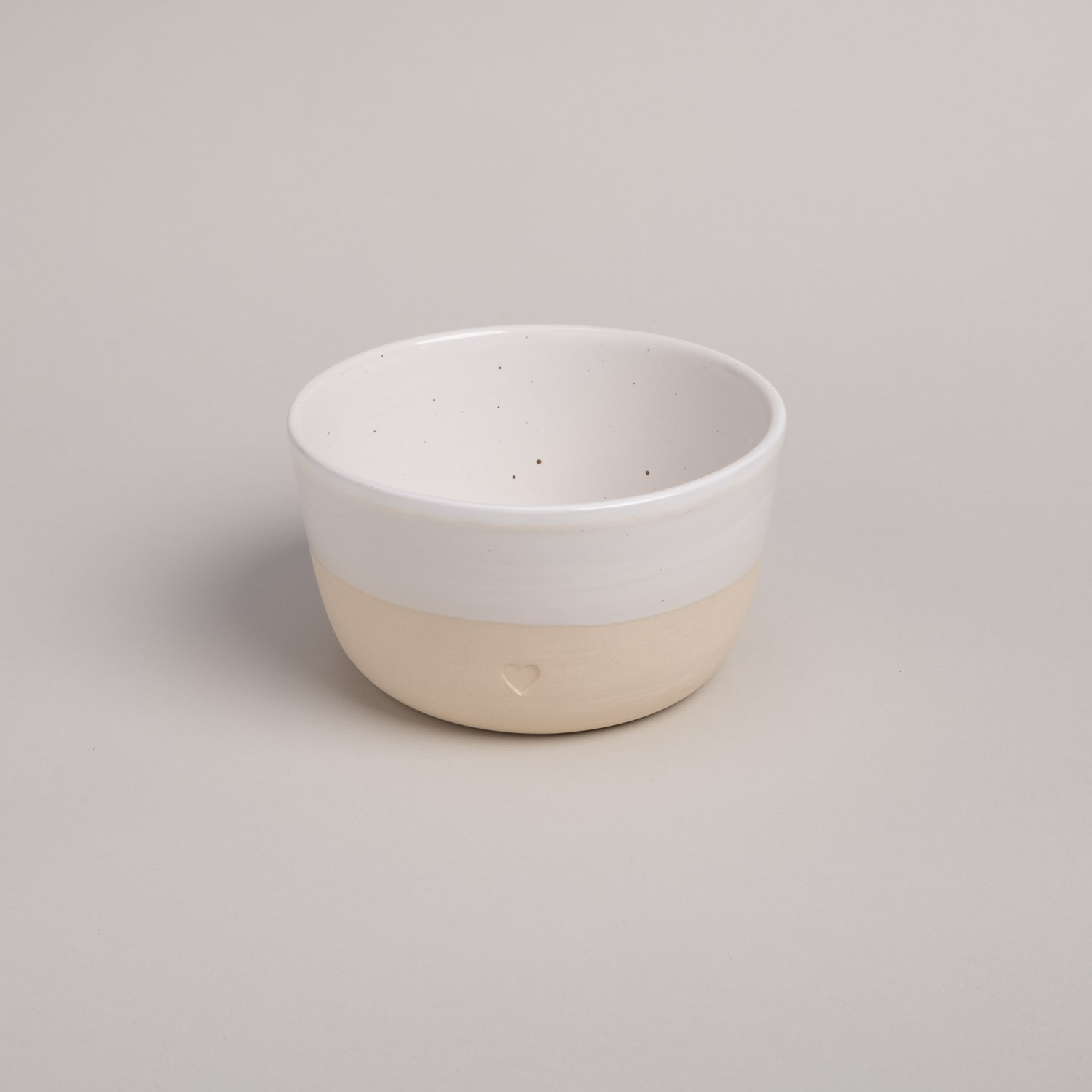 a bowl with a blind embossing in the shape of a heart.