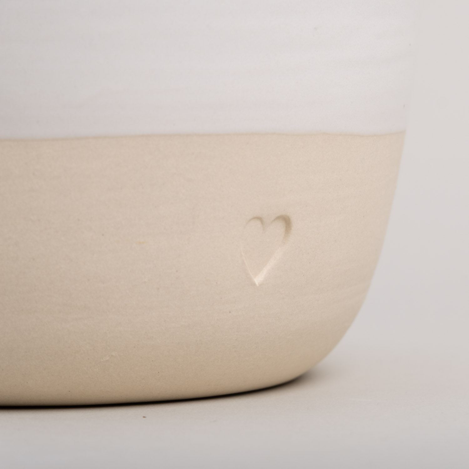 a bowl with a blind embossing in the shape of a heart.