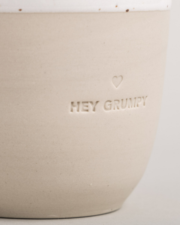 Handcrafted Portuguese Hey Grumpy Stoneware Mug - Unique, Minimalist 320ml Ceramic Cup. Each piece individually made by hand, featuring blind embossed design. Dishwasher safe. Dimensions: 8.5-9 cm height, 8.5 cm diameter. Celebrate artisanal craftsmanship with this one-of-a-kind drinking companion.
