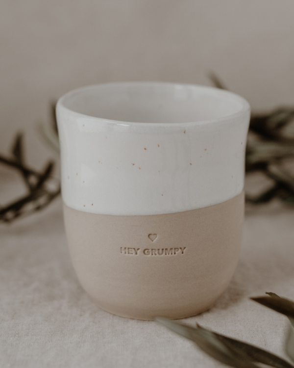 Handcrafted Portuguese Hey Grumpy Stoneware Mug - Unique, Minimalist 320ml Ceramic Cup. Each piece individually made by hand, featuring blind embossed design. Dishwasher safe. Dimensions: 8.5-9 cm height, 8.5 cm diameter. Celebrate artisanal craftsmanship with this one-of-a-kind drinking companion.
