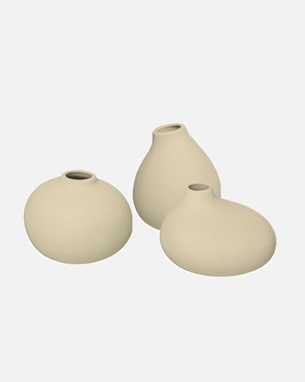 Three unglazed porcelain vases in a "Vanilla" color with a natural, organic shape. Each vase has slight variations in color and texture, creating a unique and charming set. Perfect for displaying flowers or adding a touch of earthy elegance to your home decor.