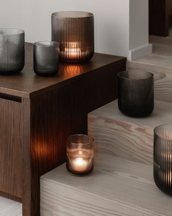 different size mouth-blown glass lanterns on a side table and stairs