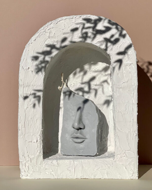 soy wax candle shaped like a face