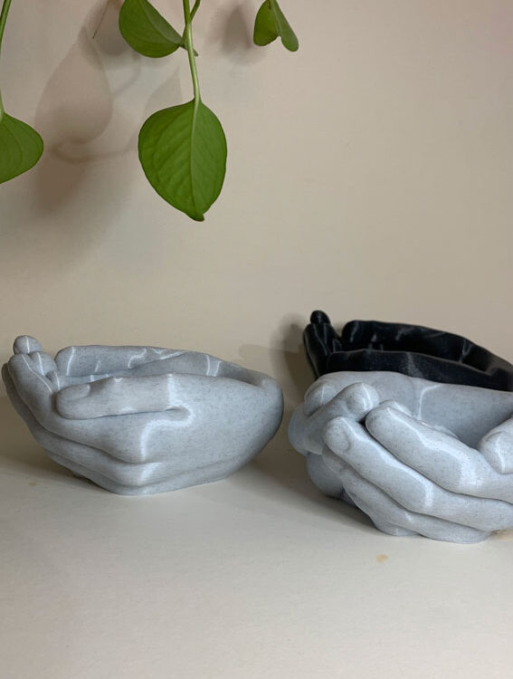 planter in the shape of hands in marble and grey shade