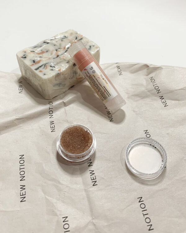 a flatlay of a gift box including a soap, a lip scrub and a lip balm all made with natural ingredients