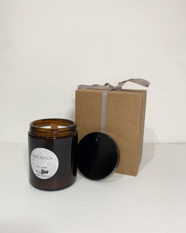a vanilla scented candle in a dark black vessel