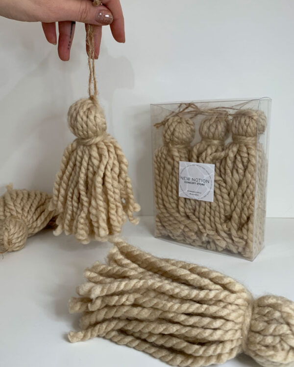 Set of 3 christmas beige yarn tassels hanging.