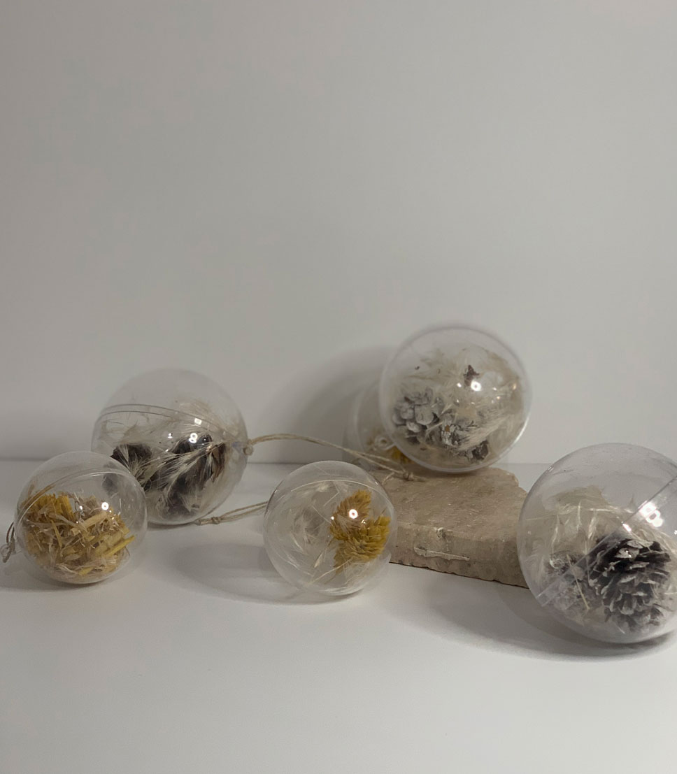 Set of 3 clear plastic baubles filled with dried pine branches and pampas grass, perfect for adding a rustic touch to holiday decorations.