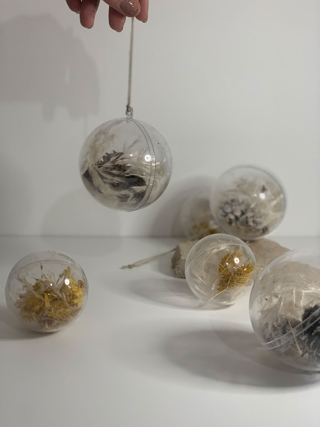 Set of 3 clear plastic baubles filled with dried pine branches and pampas grass, perfect for adding a rustic touch to holiday decorations.