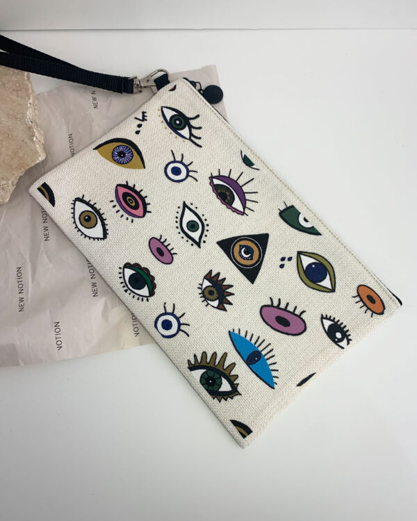 pouch with a design influenced by tarot cards. full of eyes in different colours and designs