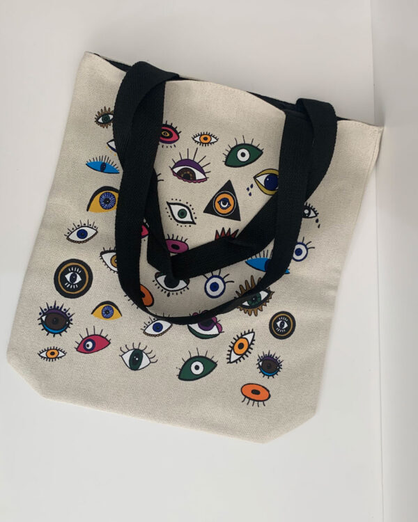 tote bag with a design influenced by tarot cards. full of eyes in different colours and designs