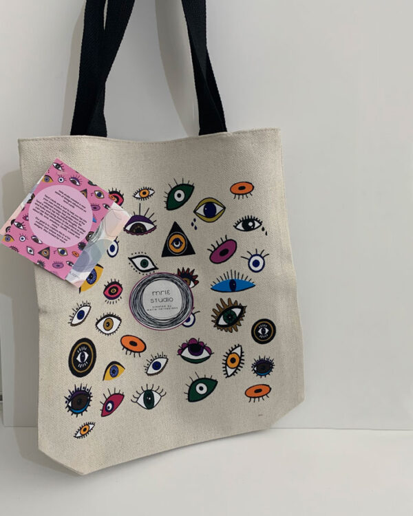 tote bag with a design influenced by tarot cards. full of eyes in different colours and designs