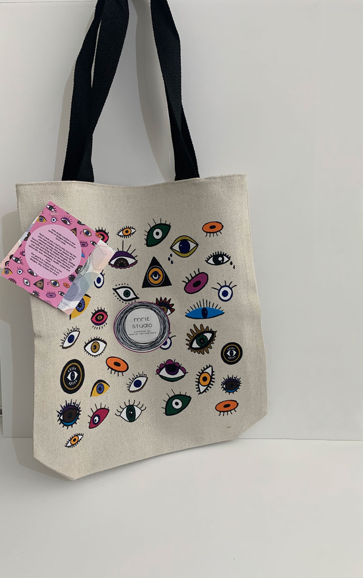 tote bag with a design influenced by tarot cards. full of eyes in different colours and designs