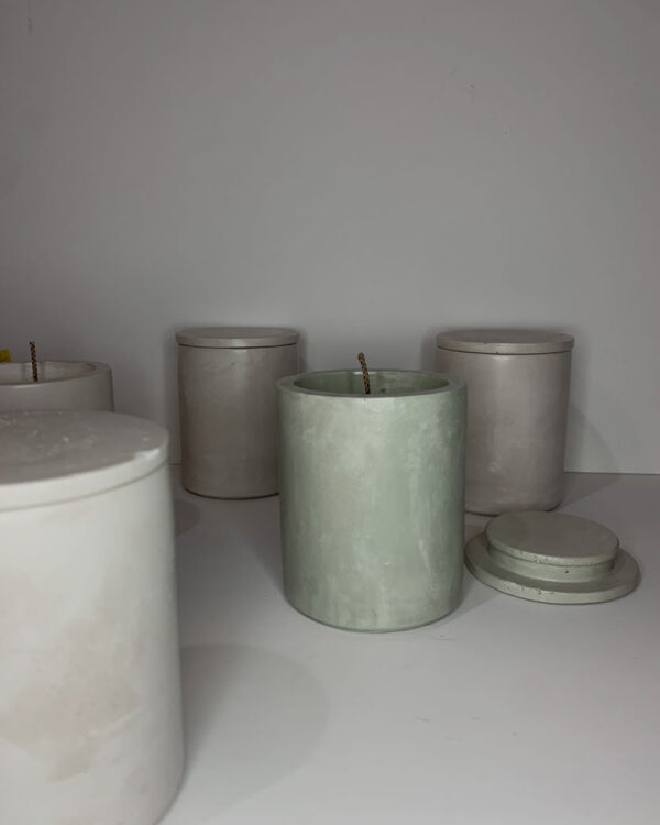 scented candle in a cylindrical concrete vessel