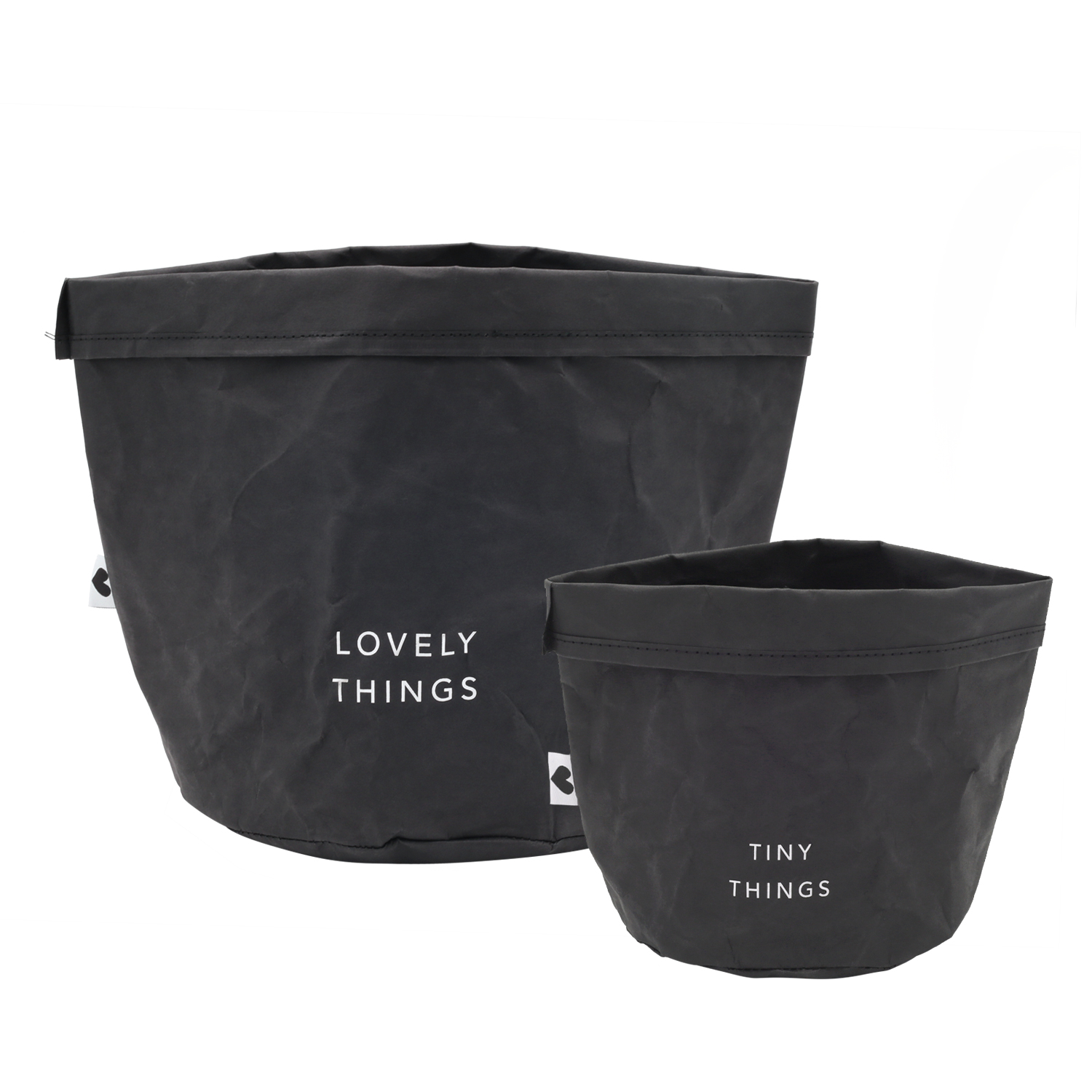paper baskets in black colour. This set consists of two paper bags in different sizes. The larger paperbag bears the slogan "Lovely Things". The smaller paper bag "Tiny Things".