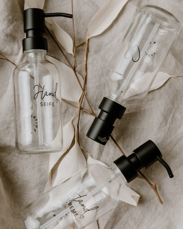 glass soap dispensers with an outline of a black heart engraved