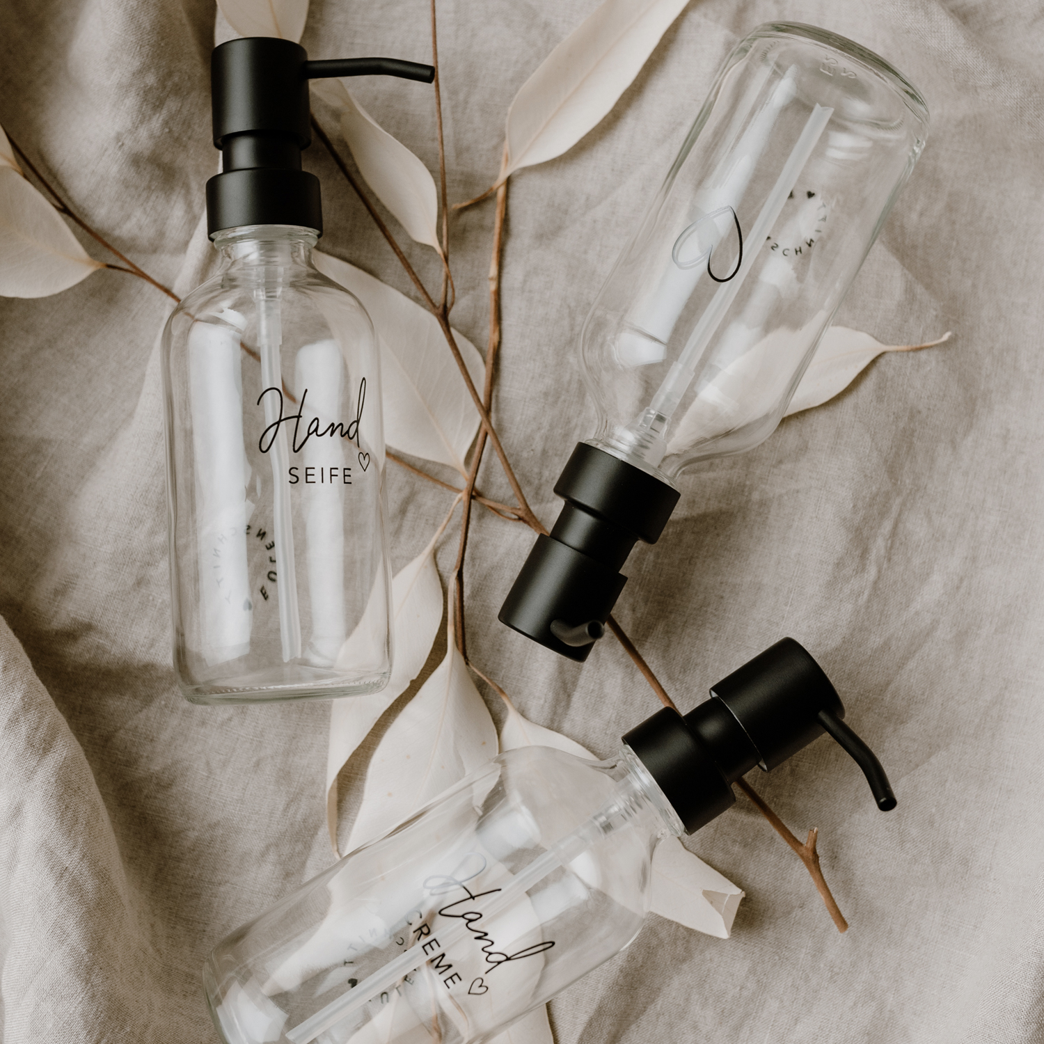 glass soap dispensers with an outline of a black heart engraved