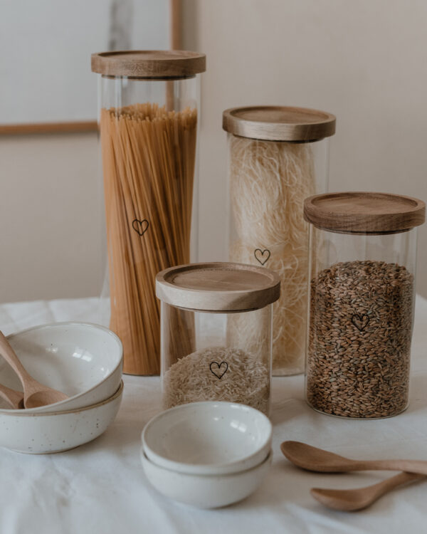storage jar in various heights filled with spaghetti