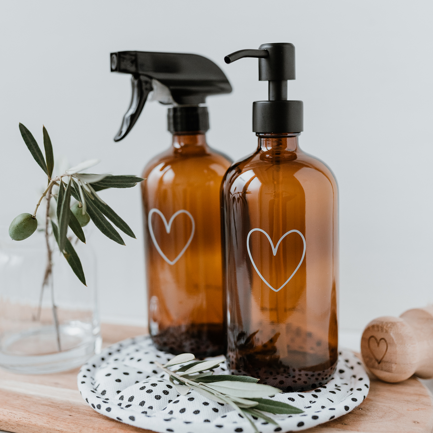 amber glass soap dispenser with an outline of a white heart engraved