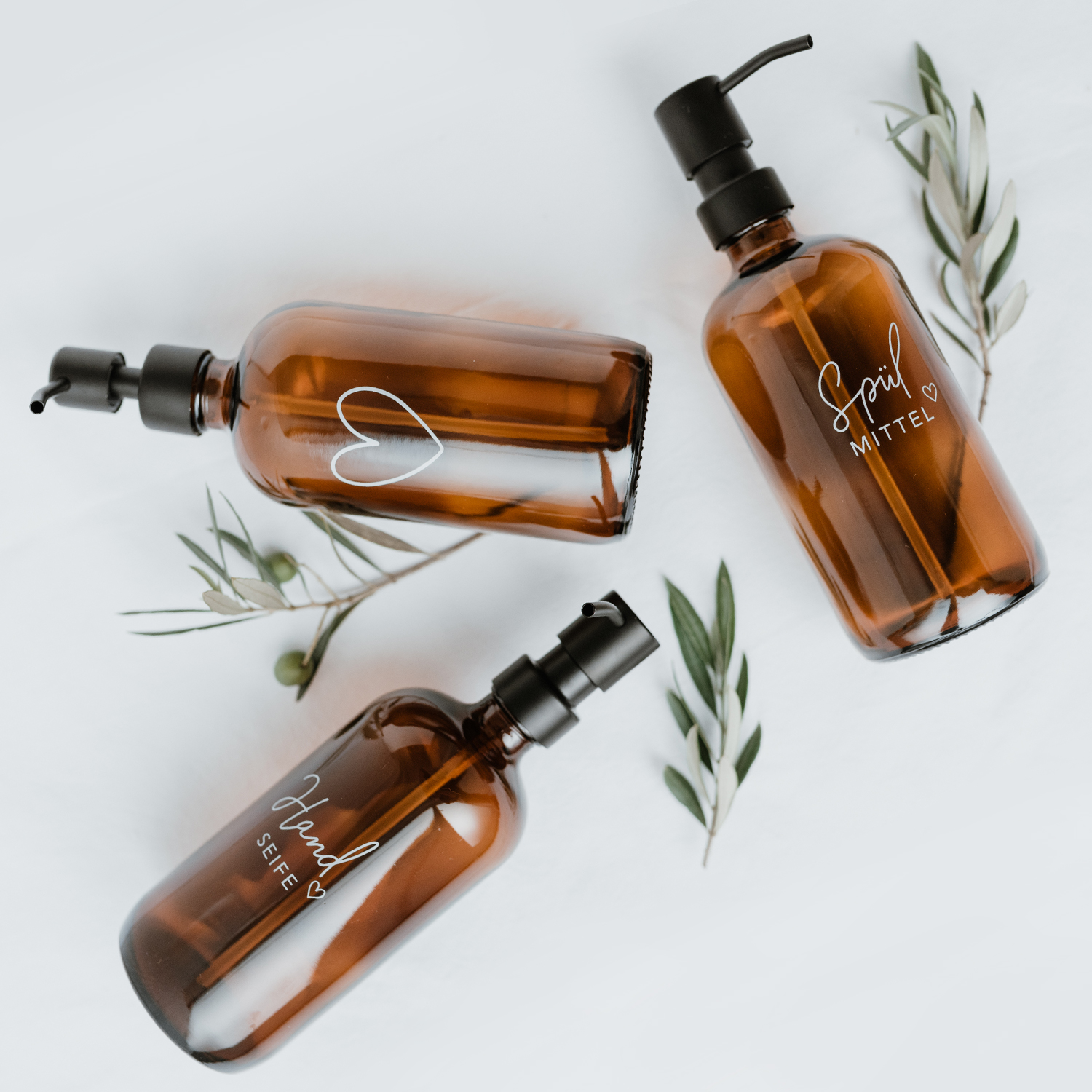 amber glass soap dispenser with an outline of a white heart engraved