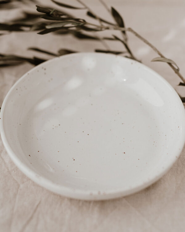 a deep plate in a cream shade with speckles