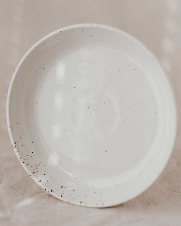 a deep plate in a cream shade with speckles
