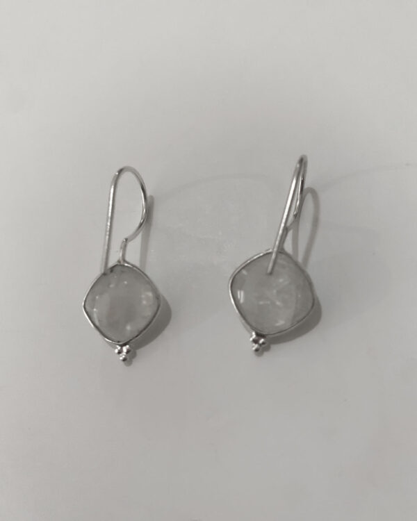 sterling silver earrings with a moonstone stone on a white background