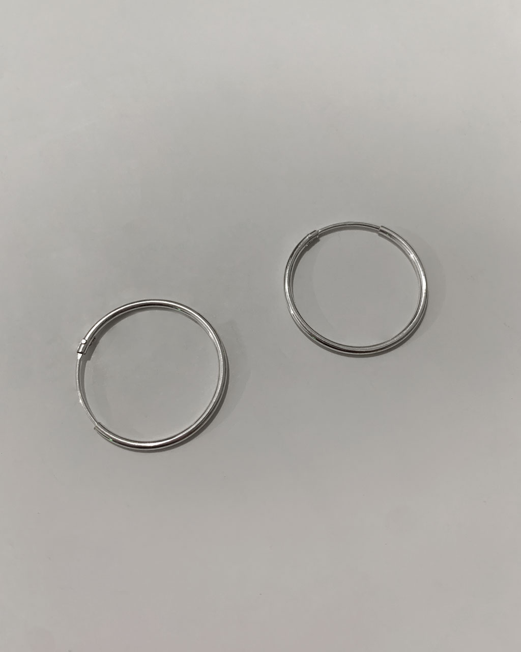 sterling silver hoop earrings on a white background