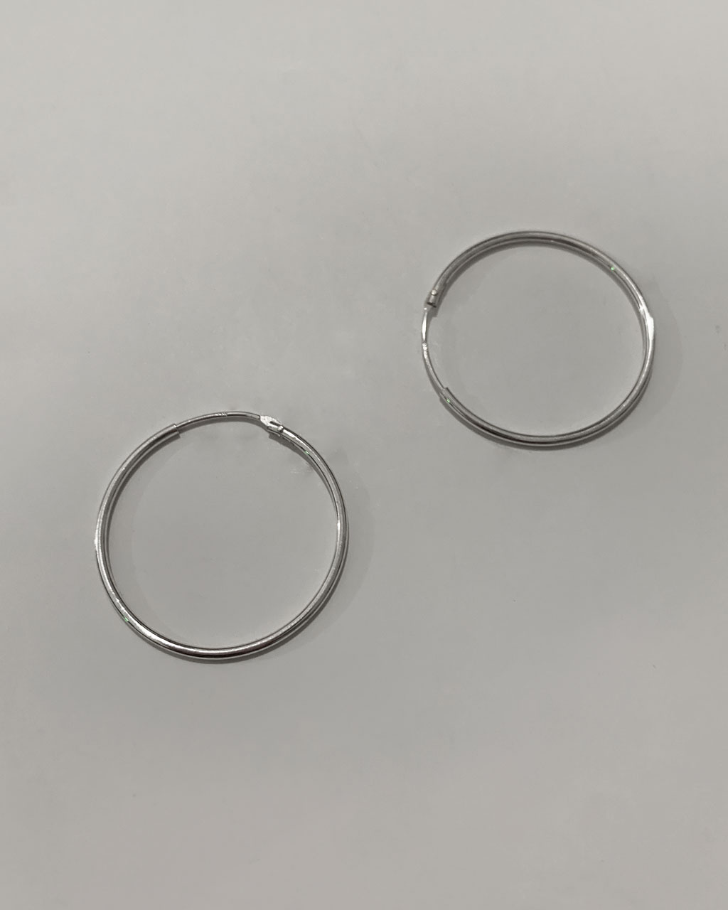 sterling silver hoop earrings on a white background