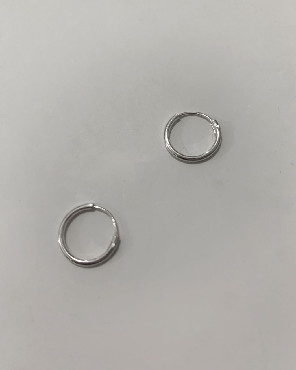 sterling silver hoop earrings on a white background