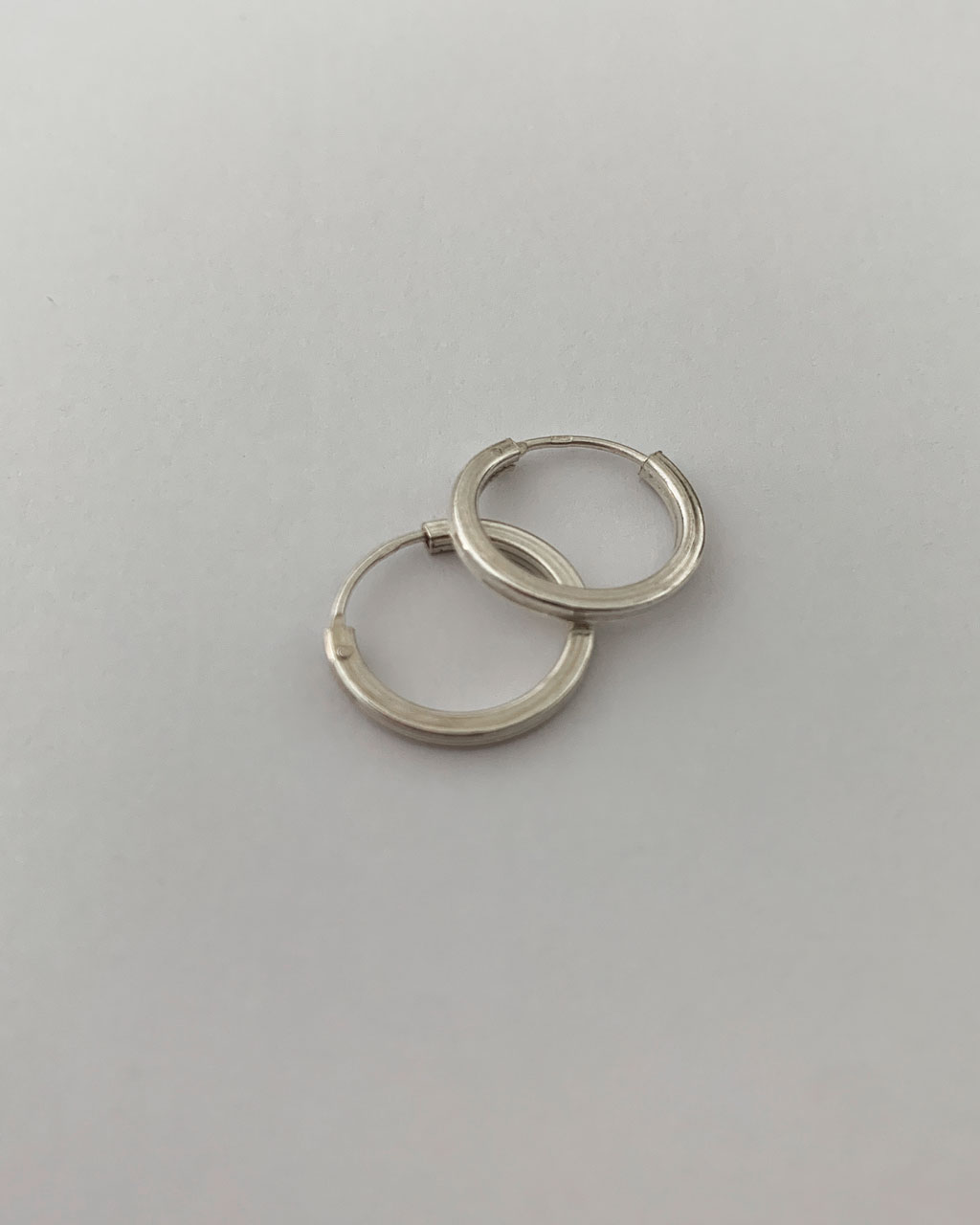 sterling silver hoop earrings on a white background