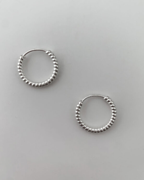 925 Sterling Silver hoop earrings that have a cool rope effect design that wraps around the entire hoop on a grey background Dimensions: 16mm x 16 mm