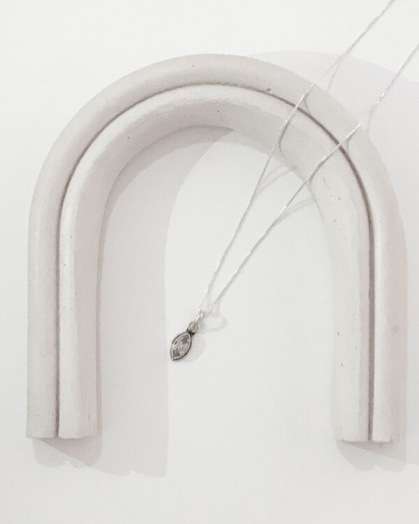 moonstone necklace on an arch on a white background
