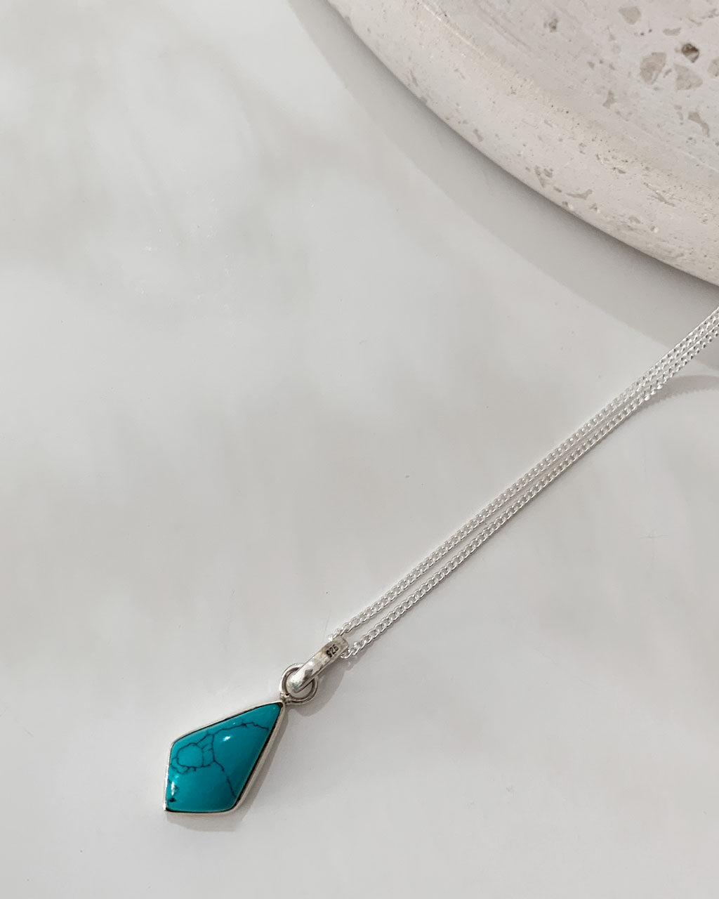 turquoise stone necklace on a white background