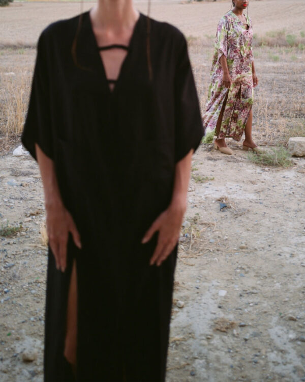 Printed satin kimono dress alongside a black kimono with high slits and pockets at the front. Comfortable fit that can be worn as casual wear or for a formal event.
