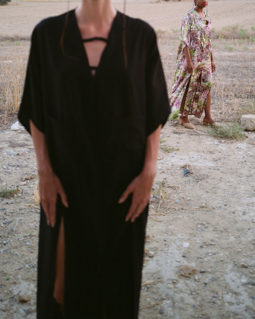 Printed satin kimono dress alongside a black kimono with high slits and pockets at the front. Comfortable fit that can be worn as casual wear or for a formal event.