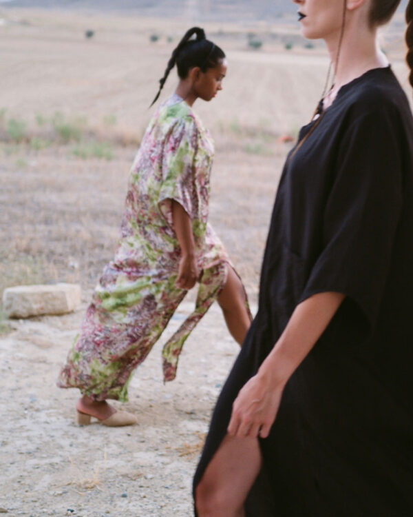 Printed satin kimono dress alongside a black kimono with high slits and pockets at the front. Comfortable fit that can be worn as casual wear or for a formal event.