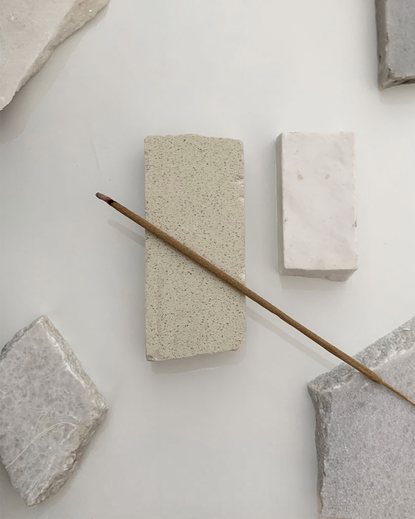 white sage incense sticks on pieces of marble