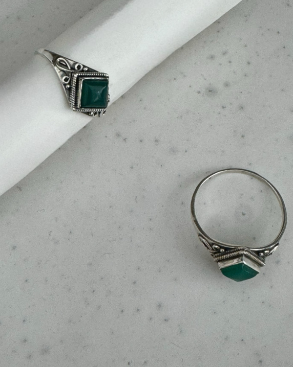 1. This stunning Green Onyx Sterling Silver Ring is the perfect accessory to add a touch of elegance and sophistication to any outfit. The vibrant green onyx stone is beautifully complemented by the sterling silver band, creating a striking contrast that is sure to catch the eye. The ring is expertly crafted with attention to detail, ensuring a high-quality piece that will last for years to come. Whether you're dressing up for a special occasion or simply want to add a pop of color to your everyday look, this Green Onyx Sterling Silver Ring is a must-have addition to your jewellery collection.