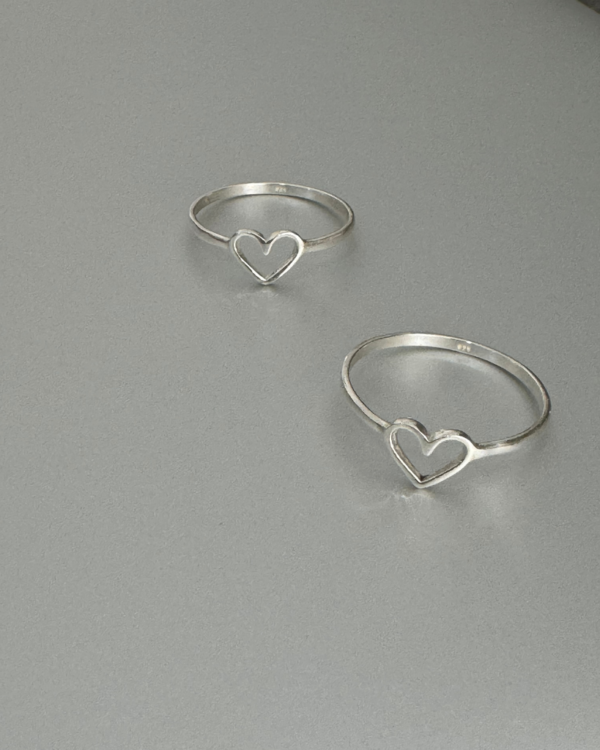 This stunning sterling silver ring features a delicate heart design, making it the perfect accessory for any romantic occasion. Crafted from high-quality sterling silver, this ring is not only beautiful but also durable, ensuring that it will last for years to come. The sleek silver band adds a modern touch to the classic heart design, making it versatile enough to be worn with any outfit, from casual to formal. Whether you're treating yourself or looking for a thoughtful gift for a loved one, this heart sterling silver ring is sure to impress. Its timeless beauty and craftsmanship make it a piece that will be treasured for a lifetime. Add a touch of romance to your look with this exquisite ring today. Silver 925.