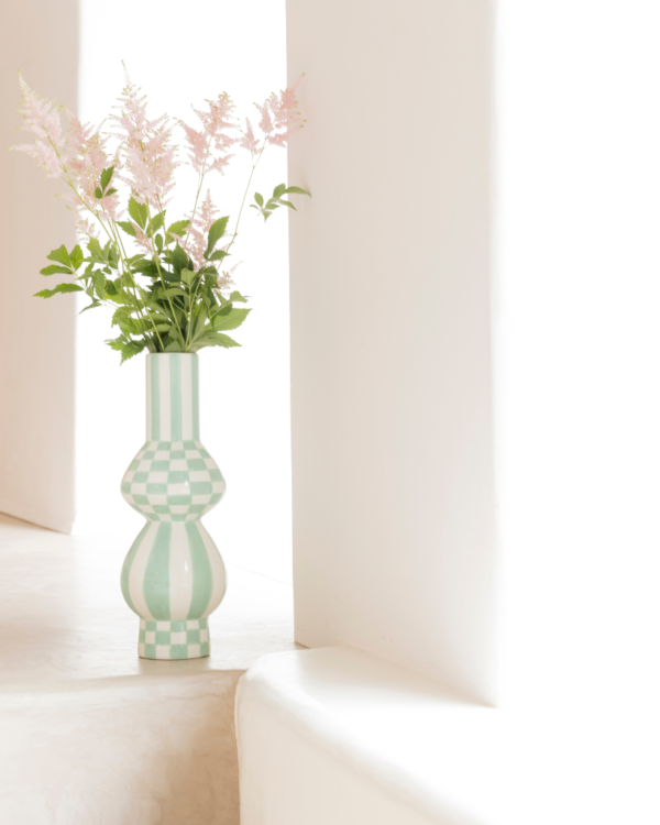 Discover the ceramic Gabriela vase from Qué Rico - a vibrant addition to your home decor. Hand-painted with a Squares & Stripes pattern, this Belgian-designed vase is a unique and colorful gift option.