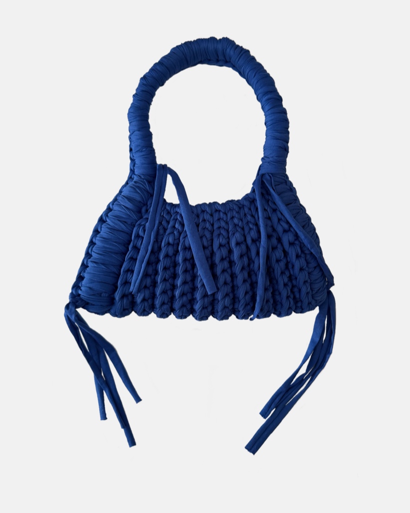 This handcrafted ocean blue bag combines style and function with its chunky crochet texture. Made from soft t-shirt yarn, it easily transitions from shoulder to handbag, making it the perfect companion from day to night. Features a stretchy yet sturdy construction that adapts to your needs.