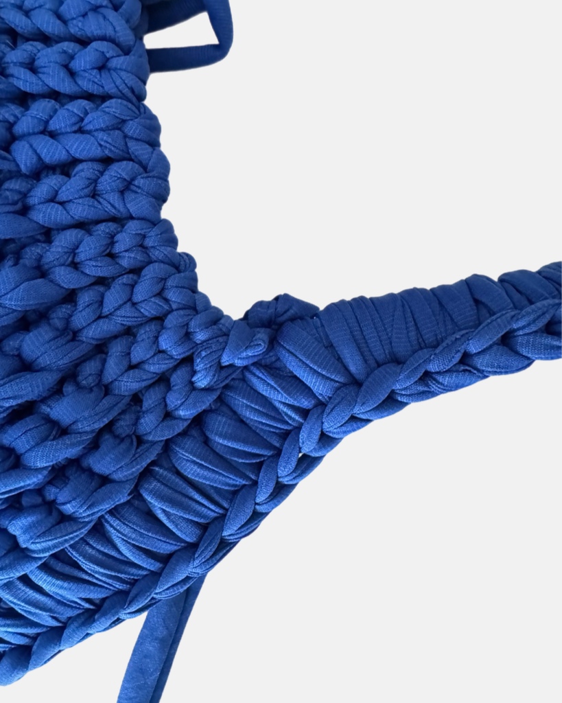 This handcrafted ocean blue bag combines style and function with its chunky crochet texture. Made from soft t-shirt yarn, it easily transitions from shoulder to handbag, making it the perfect companion from day to night. Features a stretchy yet sturdy construction that adapts to your needs.