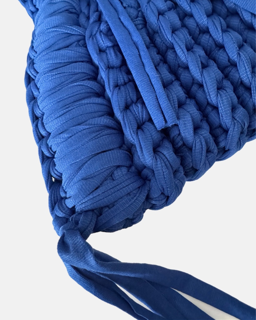 This handcrafted ocean blue bag combines style and function with its chunky crochet texture. Made from soft t-shirt yarn, it easily transitions from shoulder to handbag, making it the perfect companion from day to night. Features a stretchy yet sturdy construction that adapts to your needs.