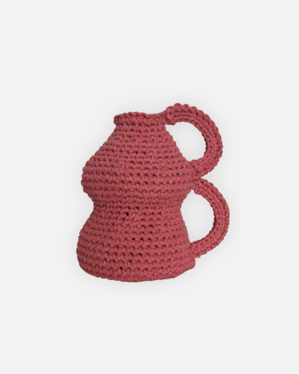This handmade crochet pink vase is a charming decorative piece that adds a touch of warmth to any space. Crafted with care over two weeks using soft cotton yarn, it showcases intricate patterns and a unique design that stands out. Perfect for holding flowers or as a standalone accent, this vase is a delightful addition to your home decor.