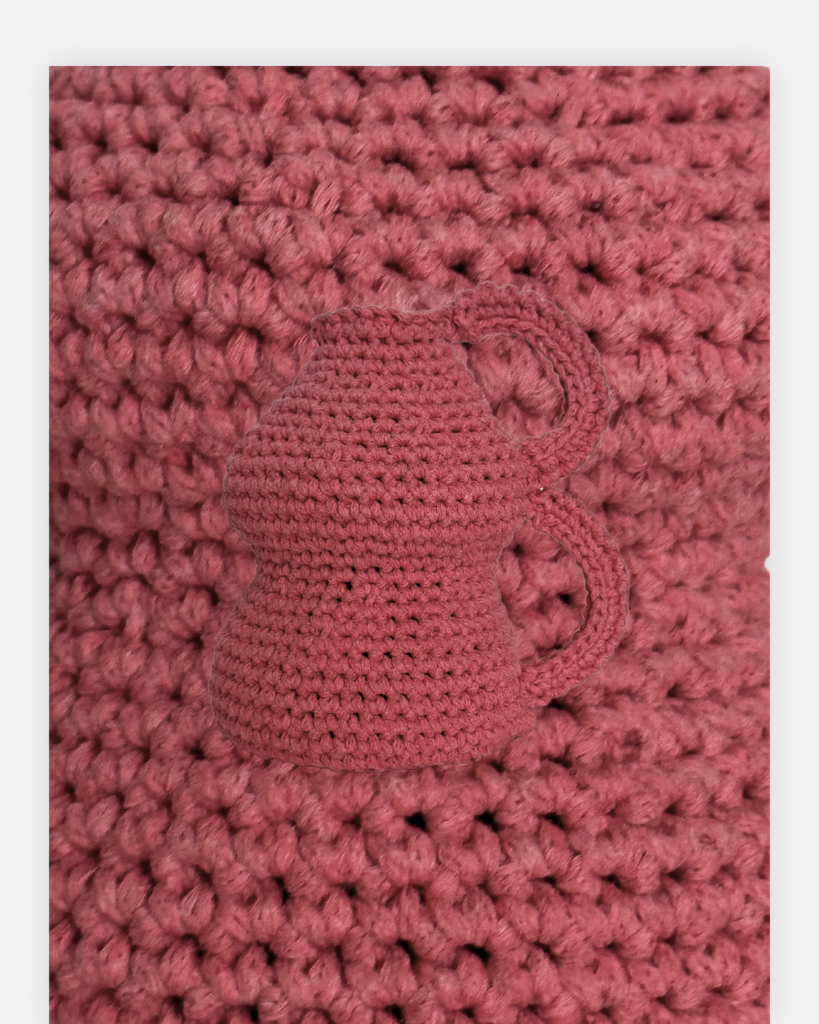 This handmade crochet pink vase is a charming decorative piece that adds a touch of warmth to any space. Crafted with care over two weeks using soft cotton yarn, it showcases intricate patterns and a unique design that stands out. Perfect for holding flowers or as a standalone accent, this vase is a delightful addition to your home decor.