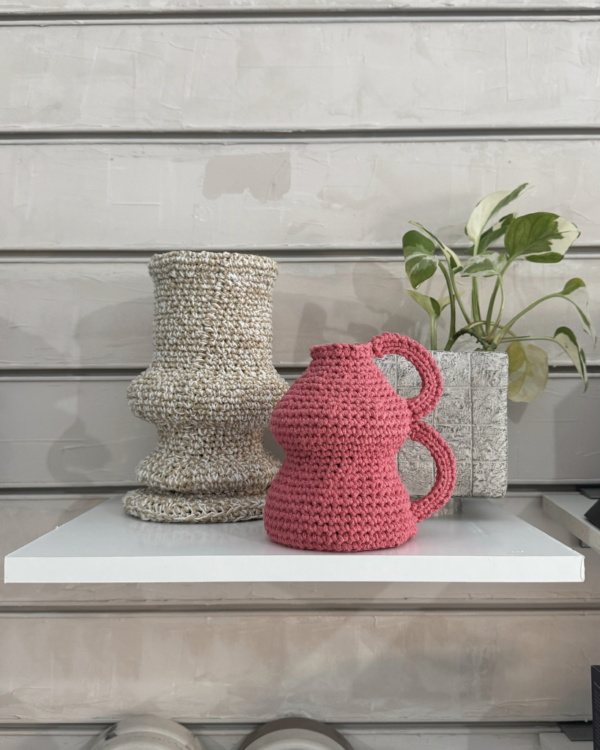 This handmade crochet pink vase is a charming decorative piece that adds a touch of warmth to any space. Crafted with care over two weeks using soft cotton yarn, it showcases intricate patterns and a unique design that stands out. Perfect for holding flowers or as a standalone accent, this vase is a delightful addition to your home decor.
