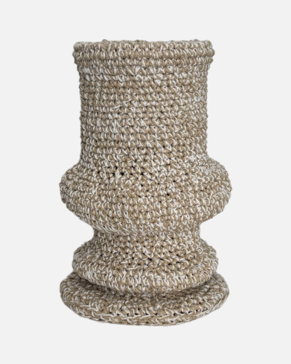 This handmade crochet ivory vase is a charming decorative piece that adds a touch of warmth to any space. Crafted with care over five weeks using soft cotton yarn, it showcases intricate patterns and a unique design that stands out. Perfect for holding flowers or as a standalone accent, this vase is a delightful addition to your home decor.