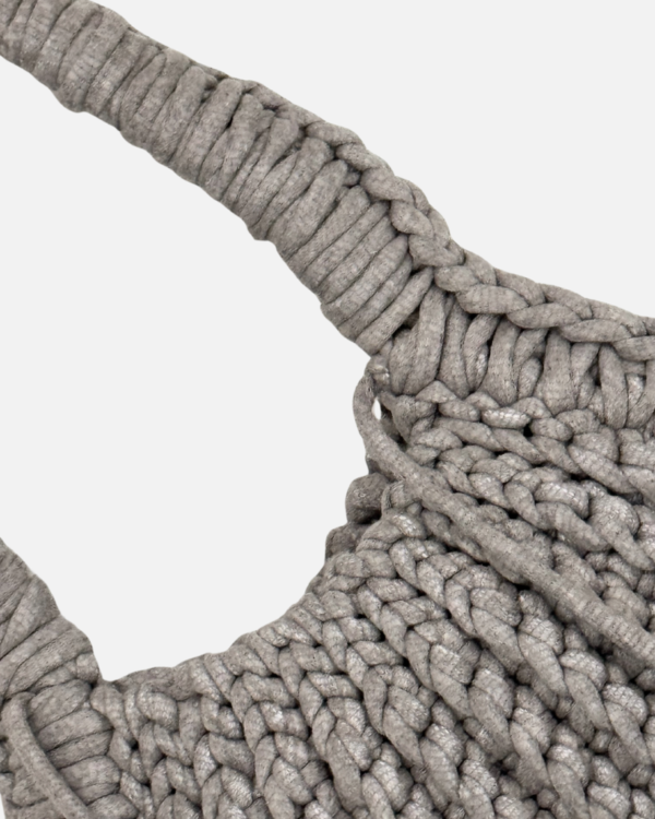 This handcrafted ash bag combines style and function with its chunky crochet texture. Made from soft t-shirt yarn, it easily transitions from shoulder to handbag, making it the perfect companion from day to night. Features a stretchy yet sturdy construction that adapts to your needs.